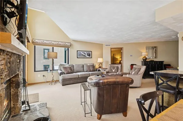 a living room with furniture a flat screen tv and a window