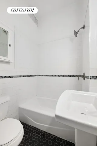 a kitchen with stainless steel appliances a stove a refrigerator cabinets and a dining table