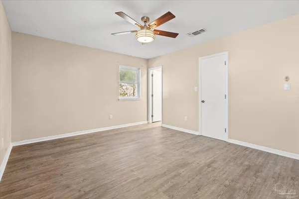 wooden floor in an empty room with a window