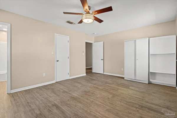 an empty room with fan and a ceiling fan