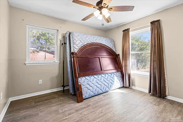 a view of a livingroom with furniture window wooden floor and front door