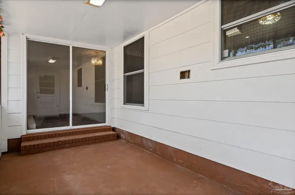 a view of an entryway with wooden floor and windows