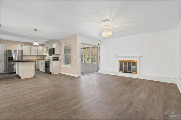a view of a kitchen with an empty space and a window