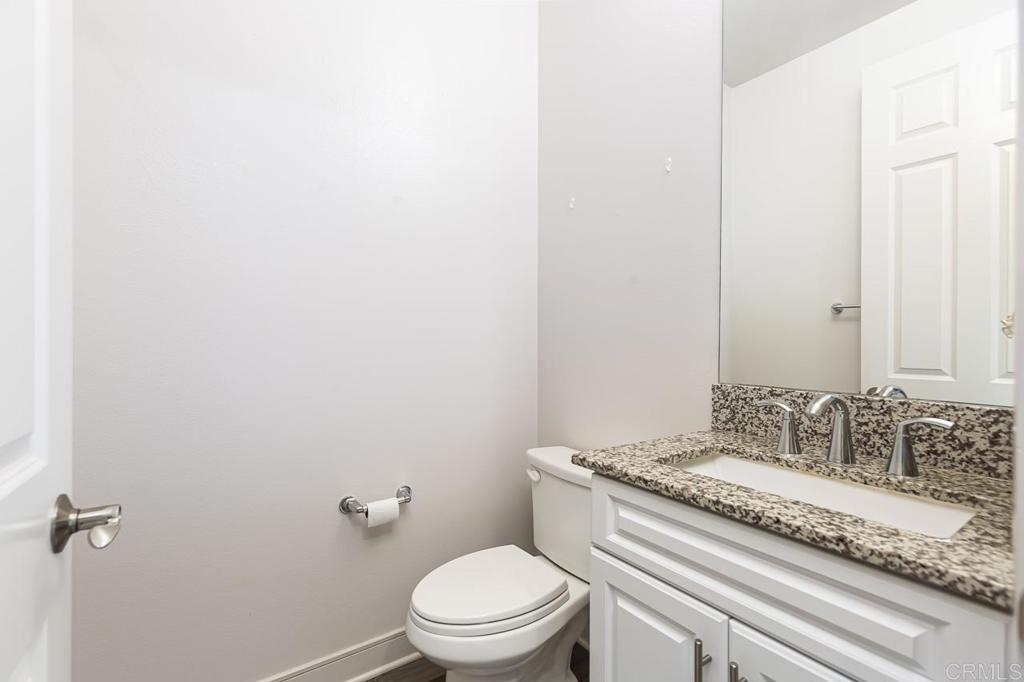 1281 Palomar Circle Escondido, CA 92027 - Photo 11 of 31 a bathroom with a granite countertop sink mirror vanity and toilet