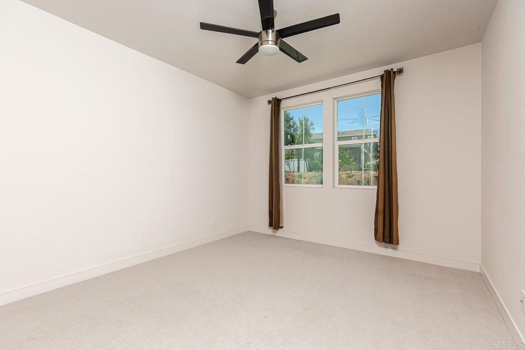 1281 Palomar Circle Escondido, CA 92027 - Photo 12 of 31 an empty room with windows and fan