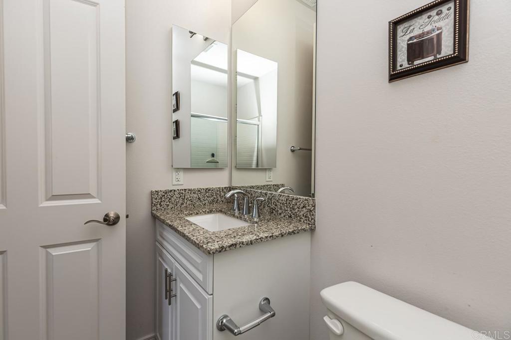 1281 Palomar Circle Escondido, CA 92027 - Photo 15 of 31 a bathroom with a granite countertop sink and a toilet