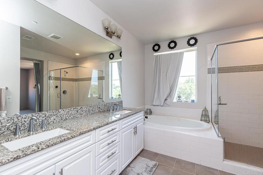 1281 Palomar Circle Escondido, CA 92027 - Photo 19 of 31 a spacious bathroom with a granite countertop tub sink and mirror