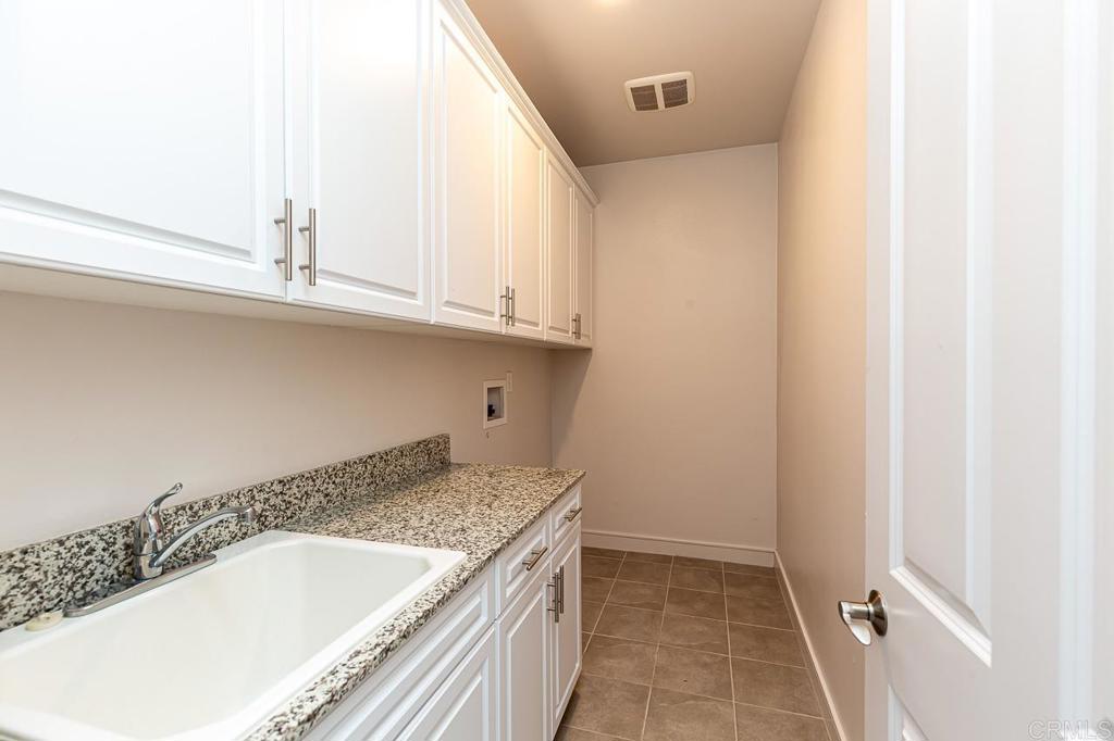 1281 Palomar Circle Escondido, CA 92027 - Photo 21 of 31 a bathroom with a granite countertop sink and bathtub