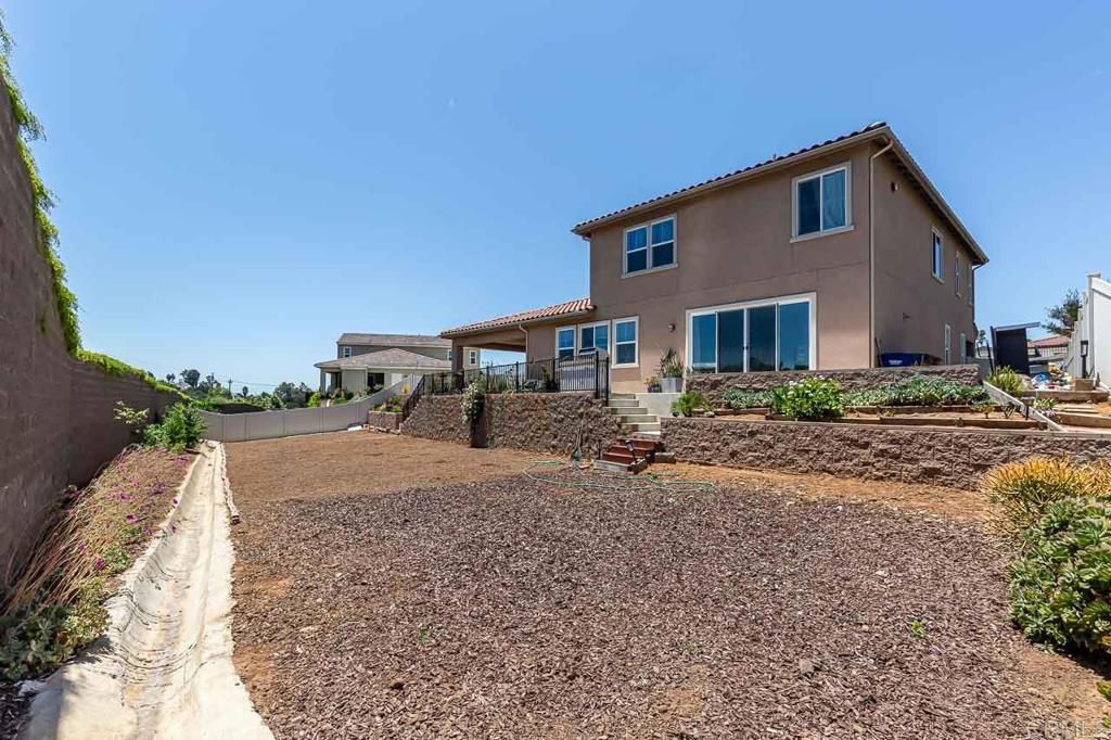 1281 Palomar Circle Escondido, CA 92027 - Photo 27 of 31 a front view of a house with a yard and garage