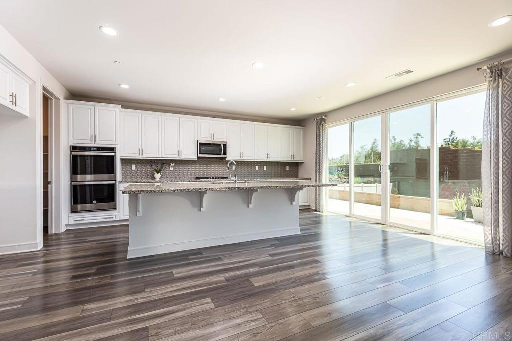 1281 Palomar Circle Escondido, CA 92027 - Photo 5 of 31 a view of kitchen with stainless steel appliances granite countertop a stove a sink and a microwave