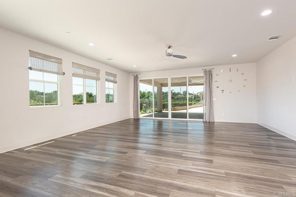 1281 Palomar Circle Escondido, CA 92027 - Photo 7 of 31 a view of an empty room with wooden floor and a window
