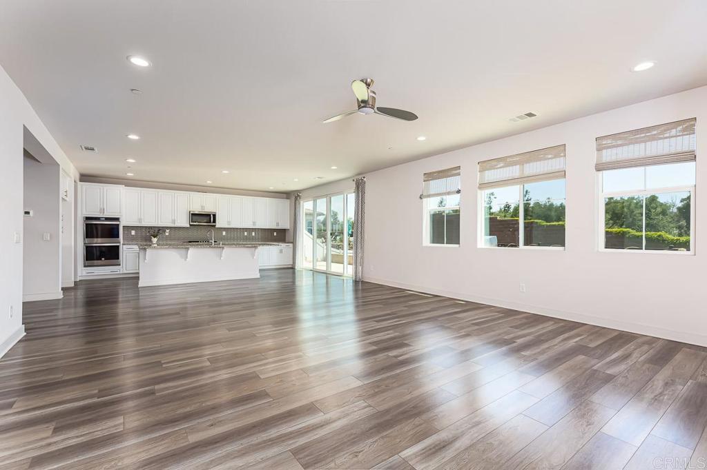 1281 Palomar Circle Escondido, CA 92027 - Photo 8 of 31 a view of a kitchen with kitchen island wooden floors and stainless steel appliances