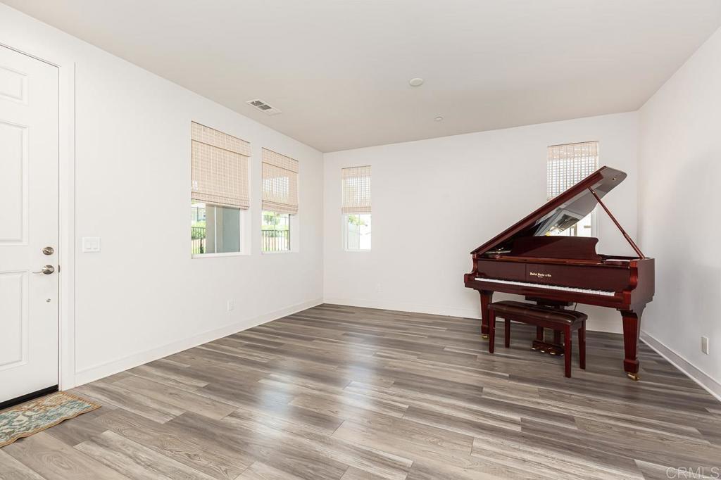 1281 Palomar Circle Escondido, CA 92027 - Photo 9 of 31 a room with a piano and wooden floor