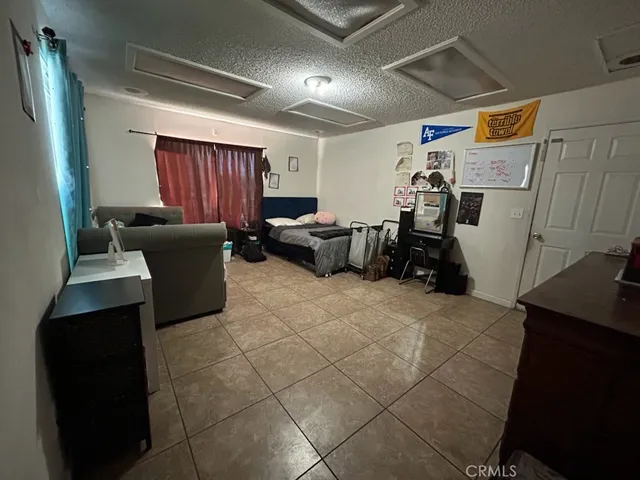 a bedroom with furniture and a flat screen tv