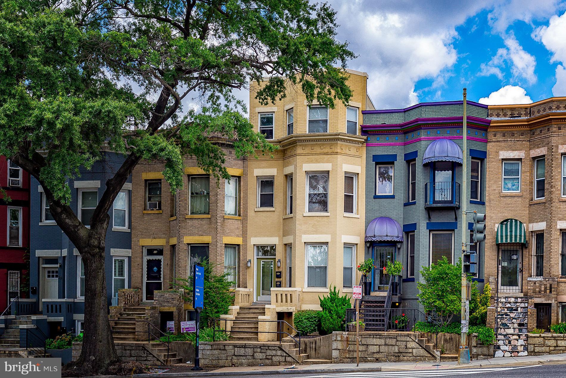 a front view of a residential apartment building with a yard