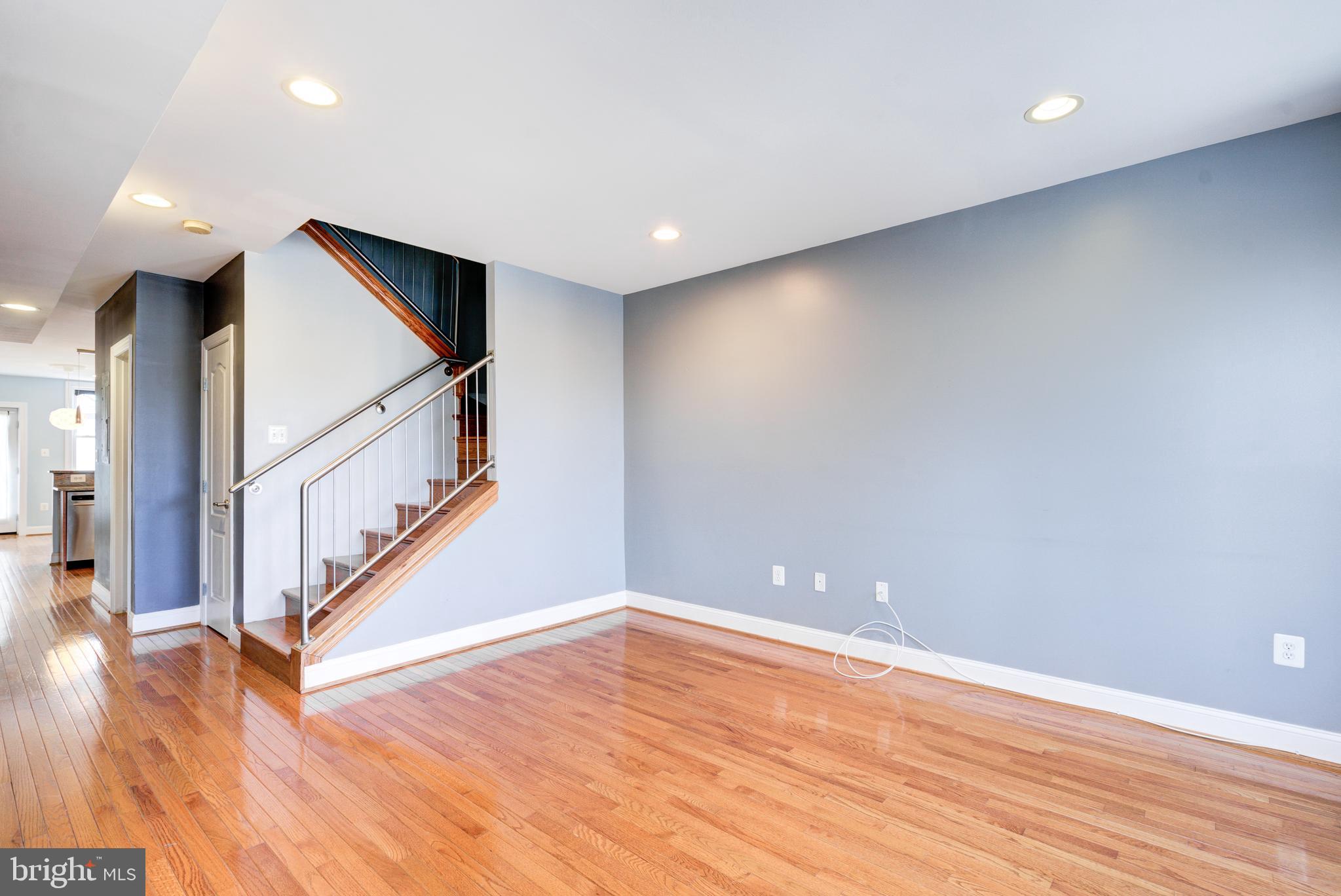 50 Rhode Island Avenue Northeast, Unit 2 Washington, DC 20002 - Photo 11 of 31 a view of an empty room with wooden floor and stairs