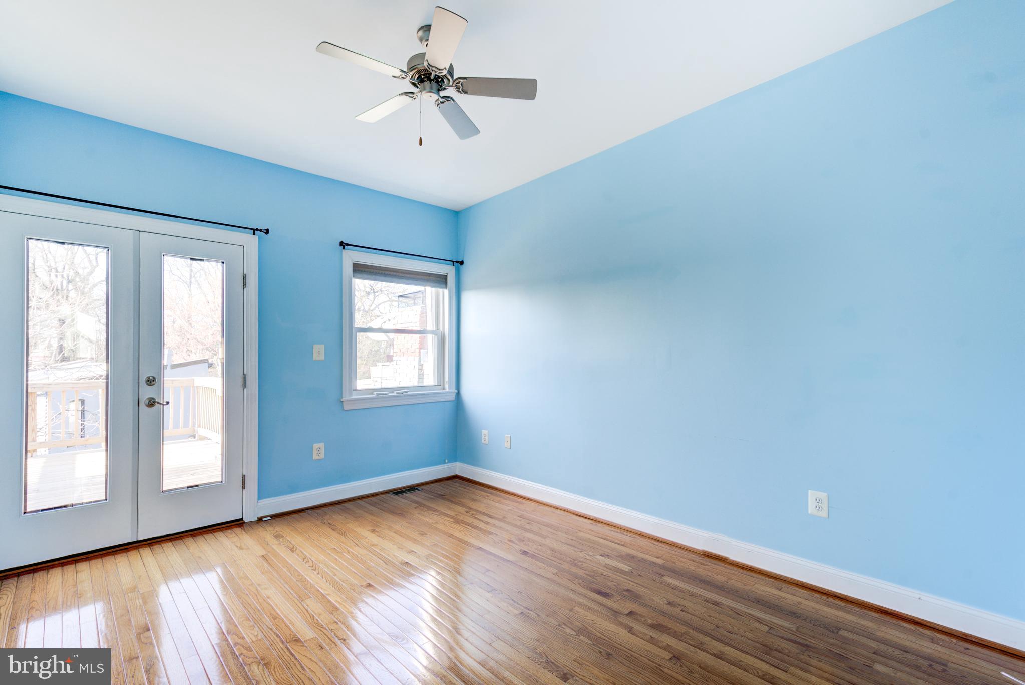 50 Rhode Island Avenue Northeast, Unit 2 Washington, DC 20002 - Photo 14 of 31 an empty room with wooden floor and windows
