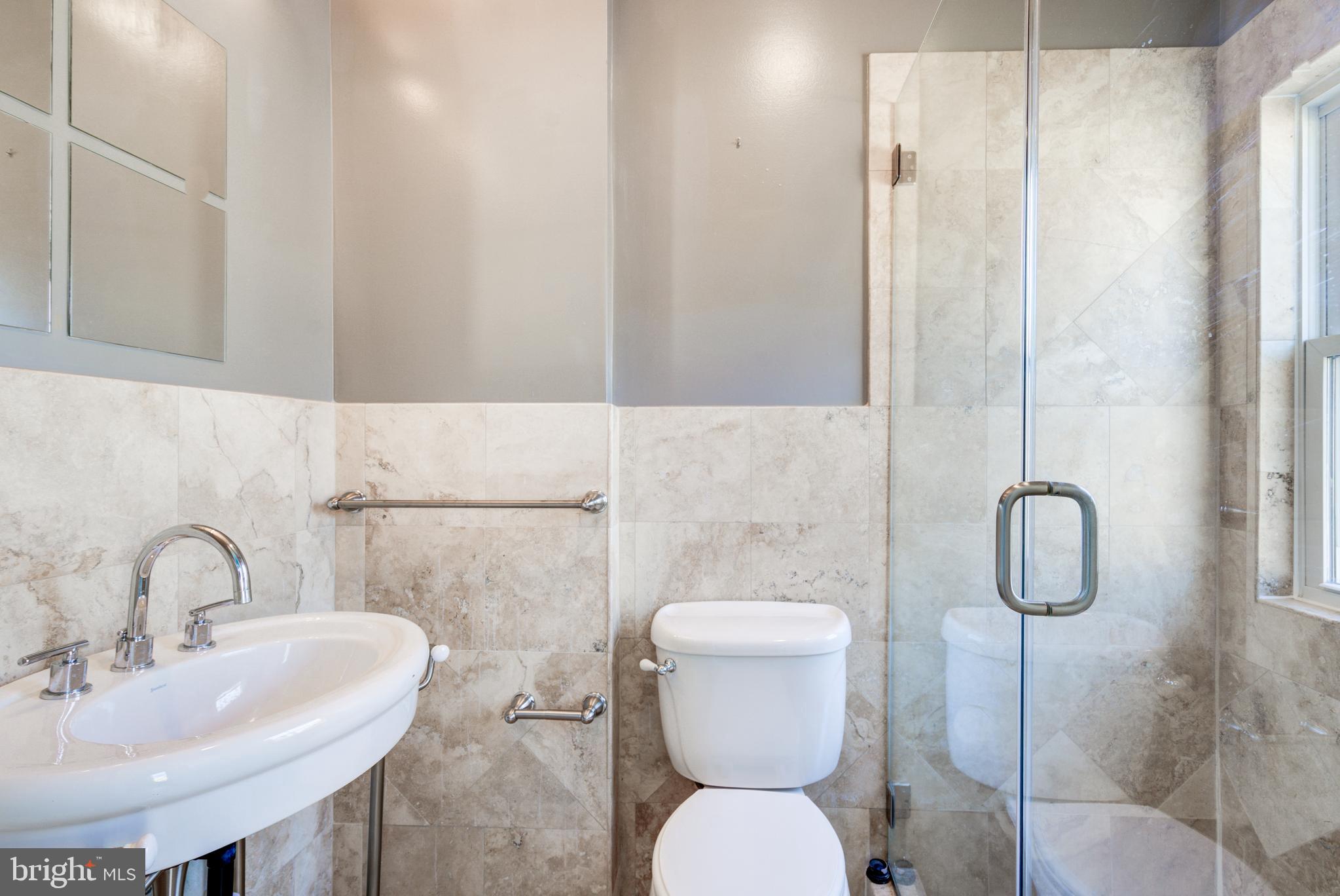50 Rhode Island Avenue Northeast, Unit 2 Washington, DC 20002 - Photo 17 of 31 a bathroom with a sink toilet and shower