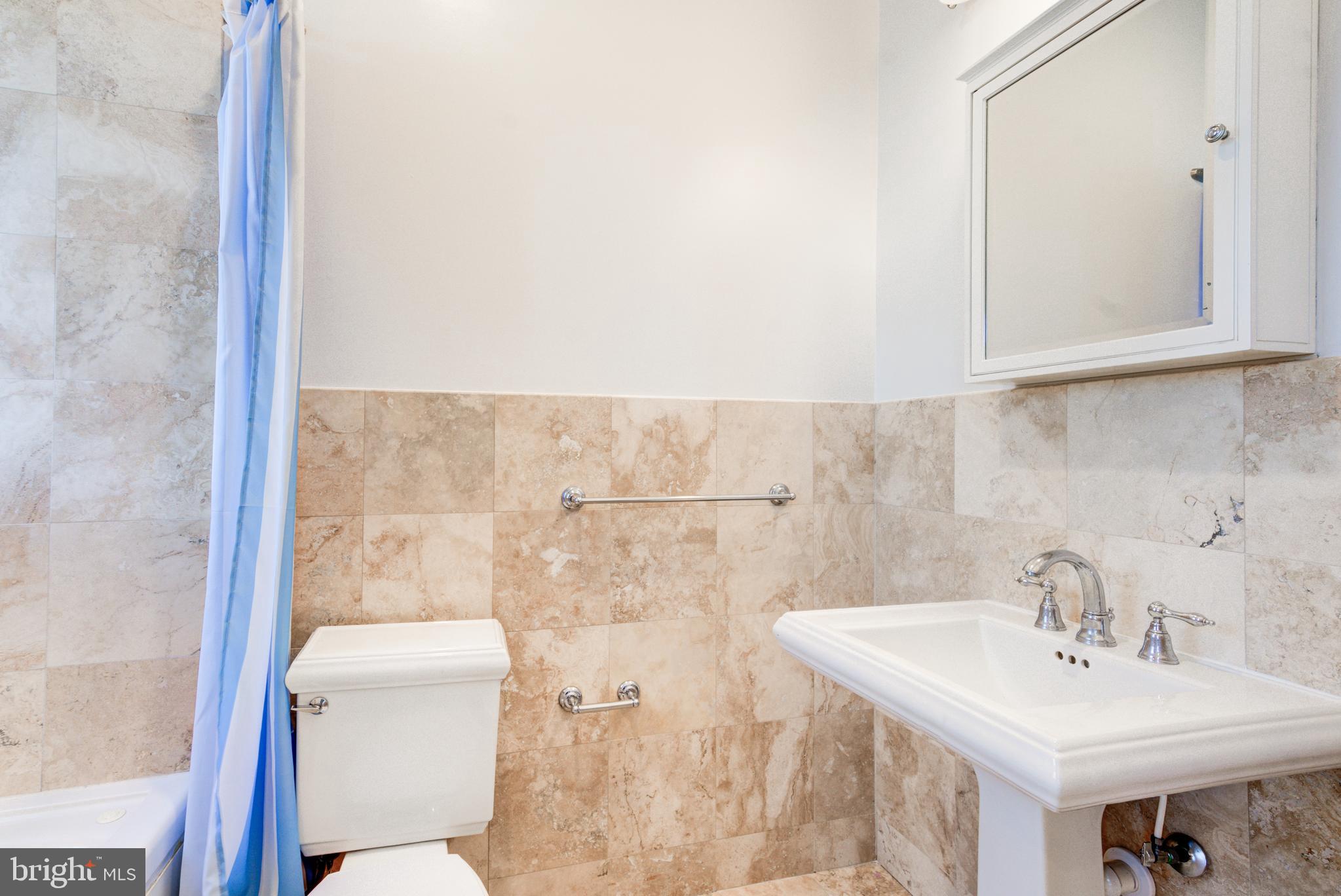 50 Rhode Island Avenue Northeast, Unit 2 Washington, DC 20002 - Photo 18 of 31 a bathroom with a sink a toilet and mirror