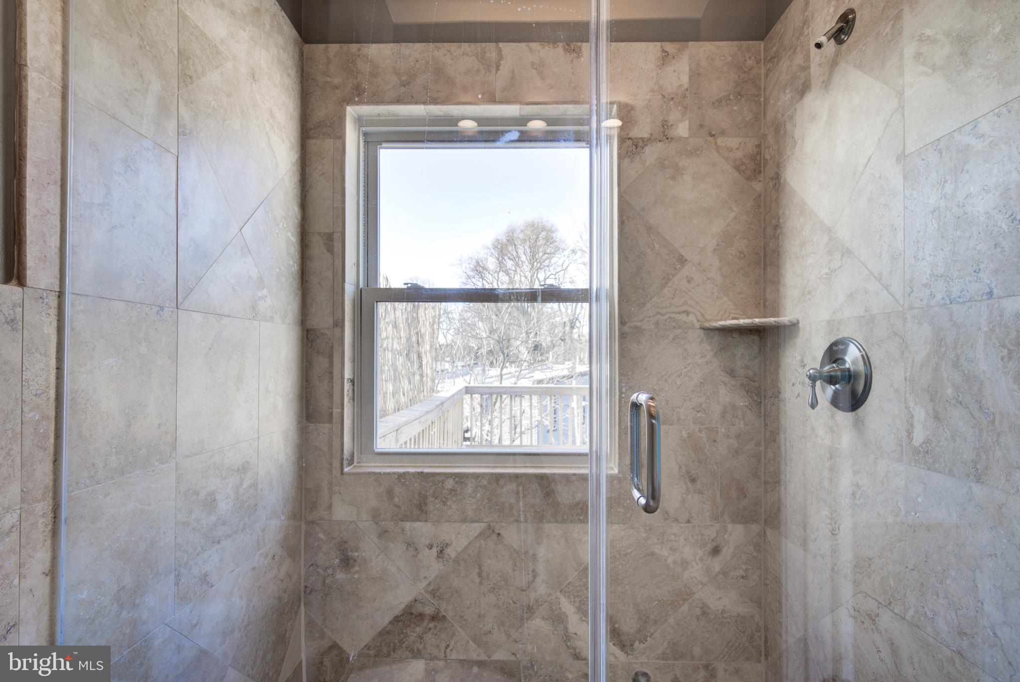 50 Rhode Island Avenue Northeast, Unit 2 Washington, DC 20002 - Photo 20 of 31 a bathroom with a window and shower