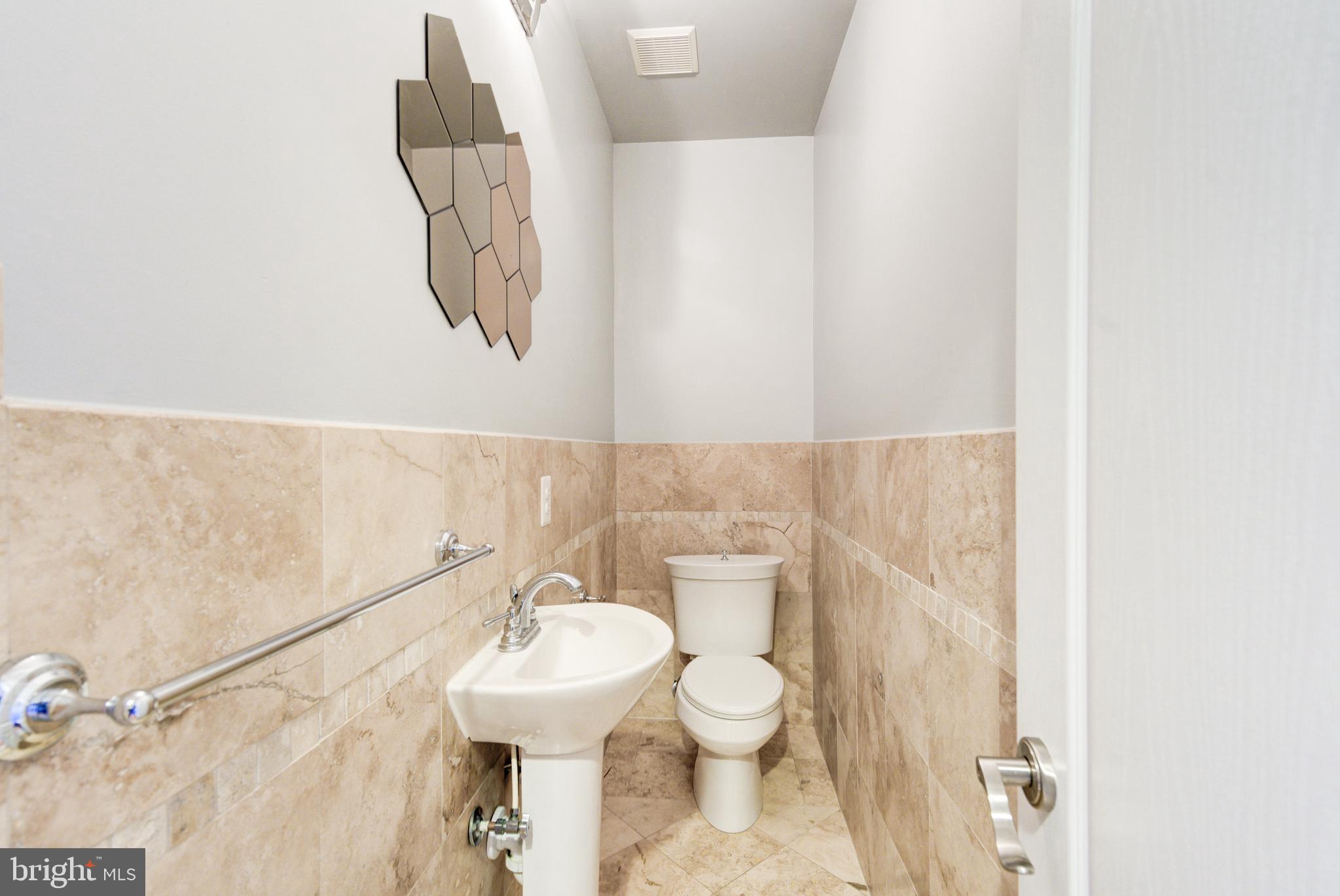 50 Rhode Island Avenue Northeast, Unit 2 Washington, DC 20002 - Photo 21 of 31 a bathroom with a toilet sink and mirror