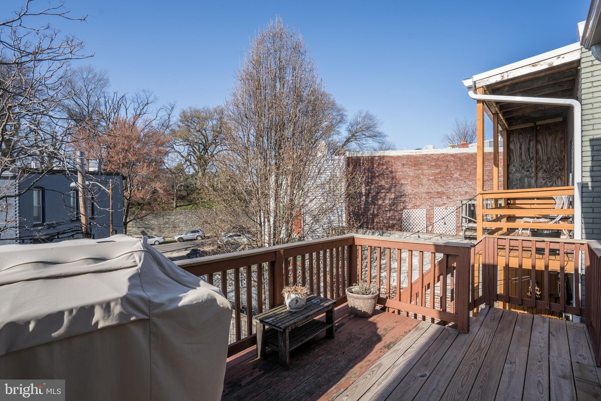 50 Rhode Island Avenue Northeast, Unit 2 Washington, DC 20002 - Photo 26 of 31 a view of a balcony with wooden floor and fence