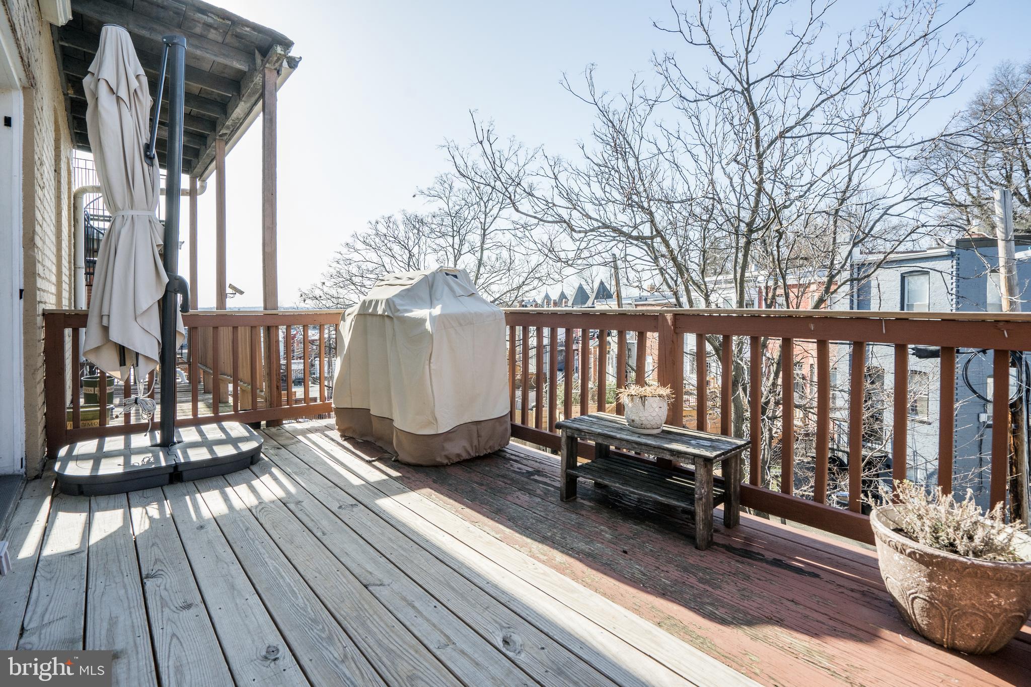 50 Rhode Island Avenue Northeast, Unit 2 Washington, DC 20002 - Photo 28 of 31 a balcony with wooden floor table and chairs