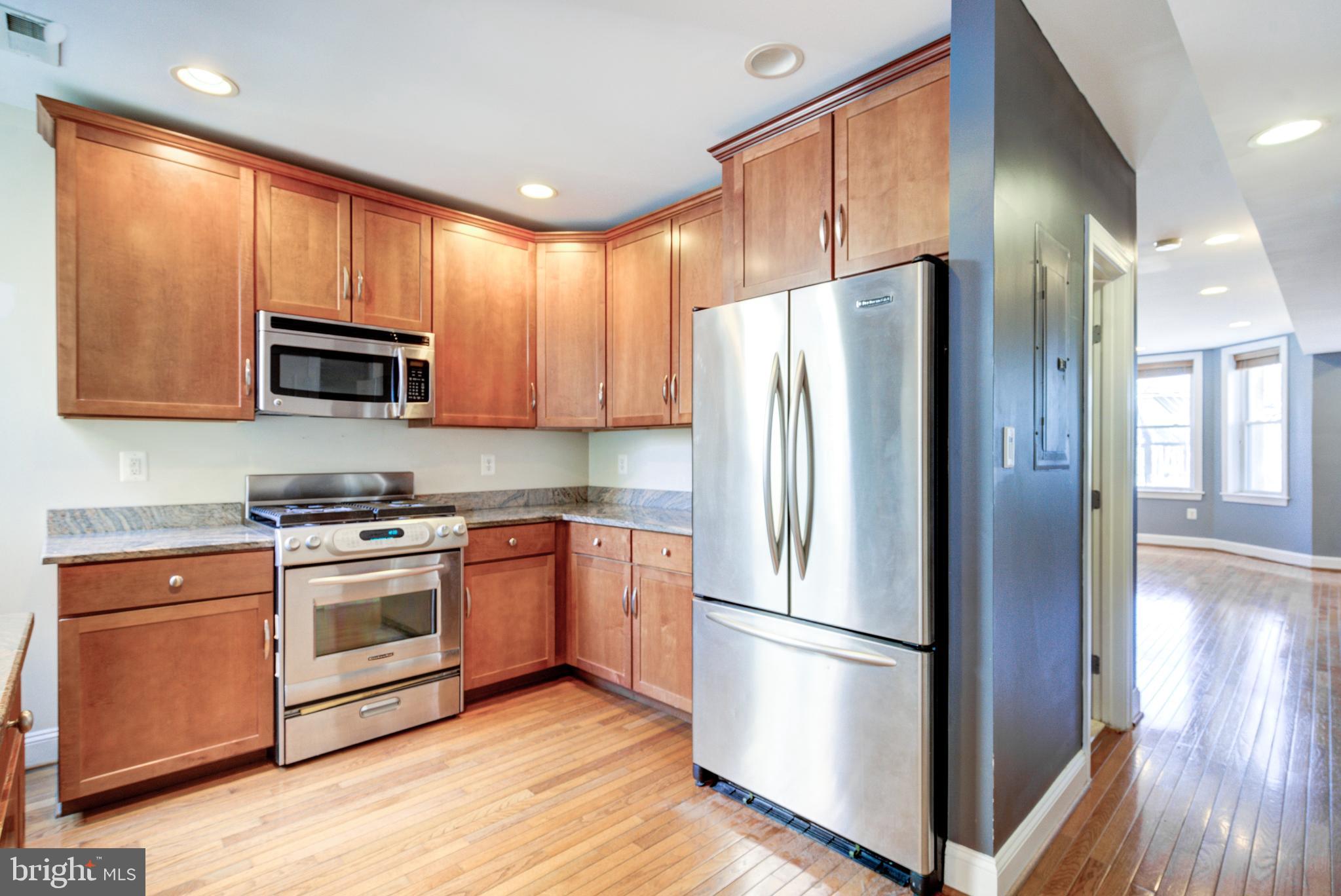 50 Rhode Island Avenue Northeast, Unit 2 Washington, DC 20002 - Photo 3 of 31 a kitchen with stainless steel appliances a refrigerator stove and microwave