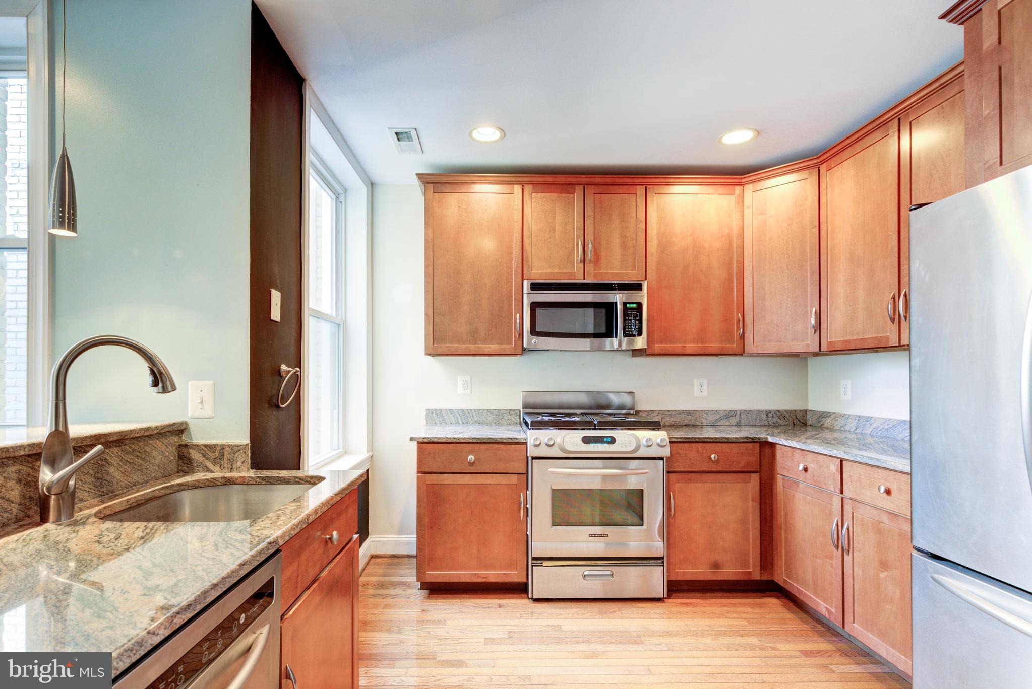50 Rhode Island Avenue Northeast, Unit 2 Washington, DC 20002 - Photo 4 of 31 a kitchen with stainless steel appliances granite countertop a stove sink and cabinets