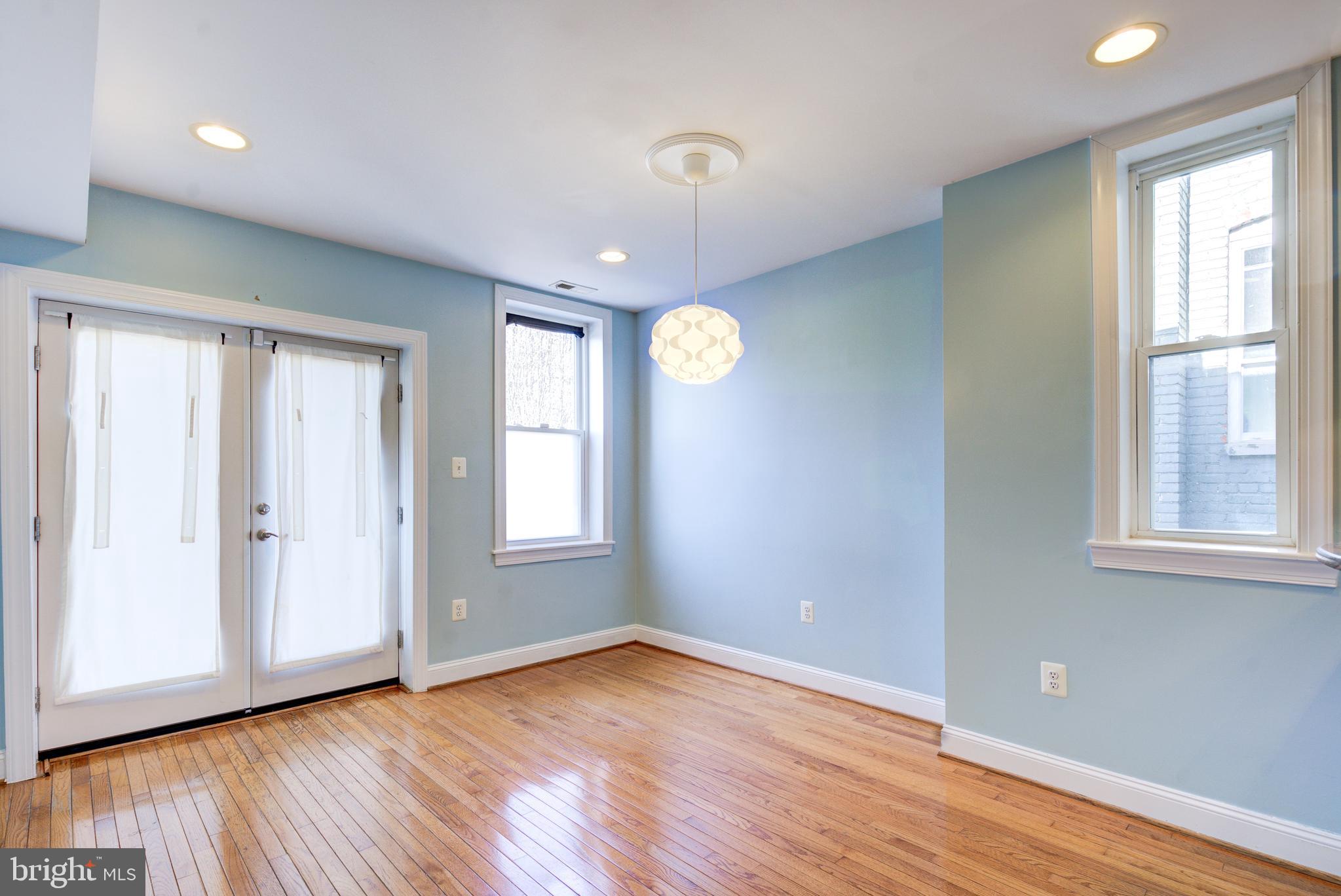 50 Rhode Island Avenue Northeast, Unit 2 Washington, DC 20002 - Photo 5 of 31 a view of an empty room with wooden floor and a window