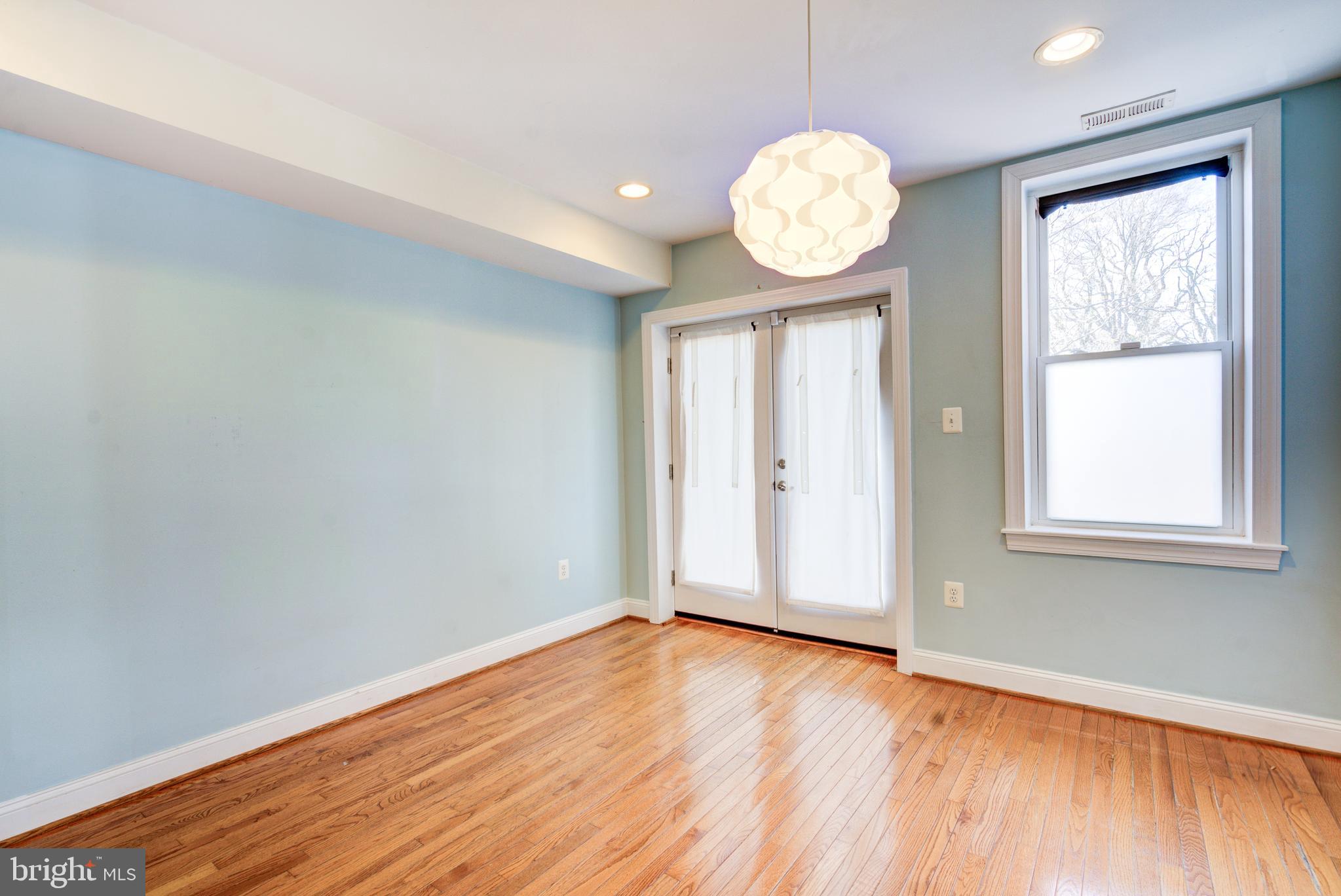 50 Rhode Island Avenue Northeast, Unit 2 Washington, DC 20002 - Photo 6 of 31 an empty room with wooden floor and windows