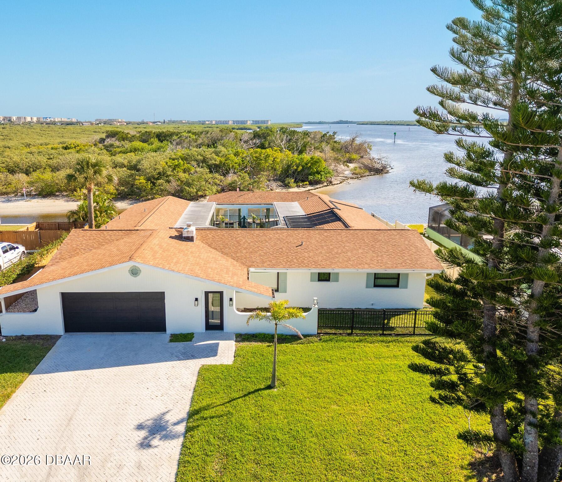a aerial view of a house with a ocean view