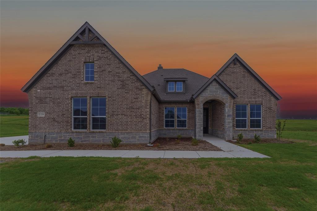 119 Hillview Trail Decatur, TX 76234 - Photo 1 of 30 Brick and stone exterior featuring an arched entryway, gabled rooflines, and multiple window placements