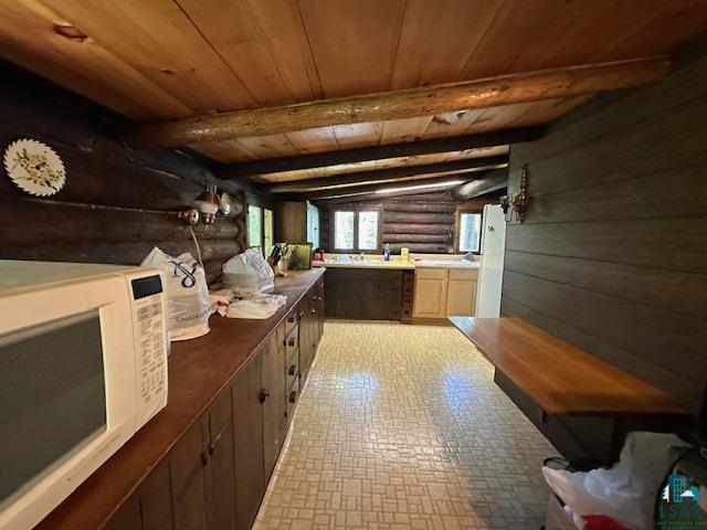 615 Kellys Lot Road Ely, MN 55731 - Photo 17 of 39 Interior space featuring beamed ceiling, wooden ceiling, tile patterned floors, and rustic walls