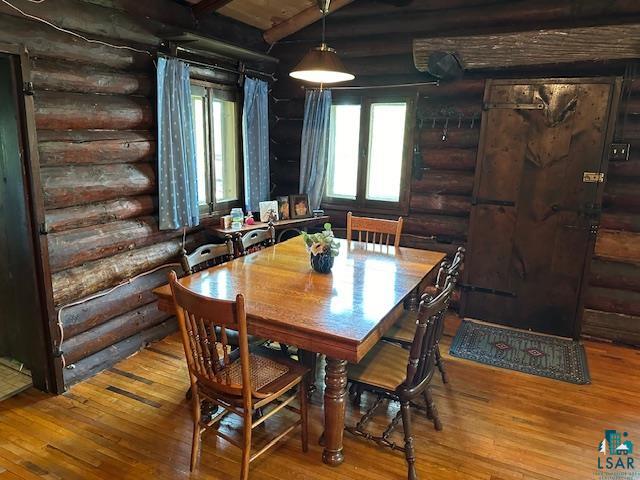 615 Kellys Lot Road Ely, MN 55731 - Photo 7 of 39 Dining room with beam ceiling, hardwood / wood-style flooring, and log walls