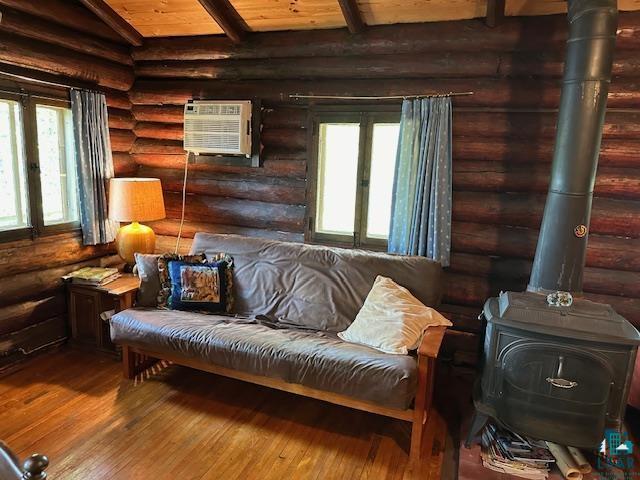 615 Kellys Lot Road Ely, MN 55731 - Photo 8 of 39 Living area with a wood stove, hardwood / wood-style flooring, and log walls