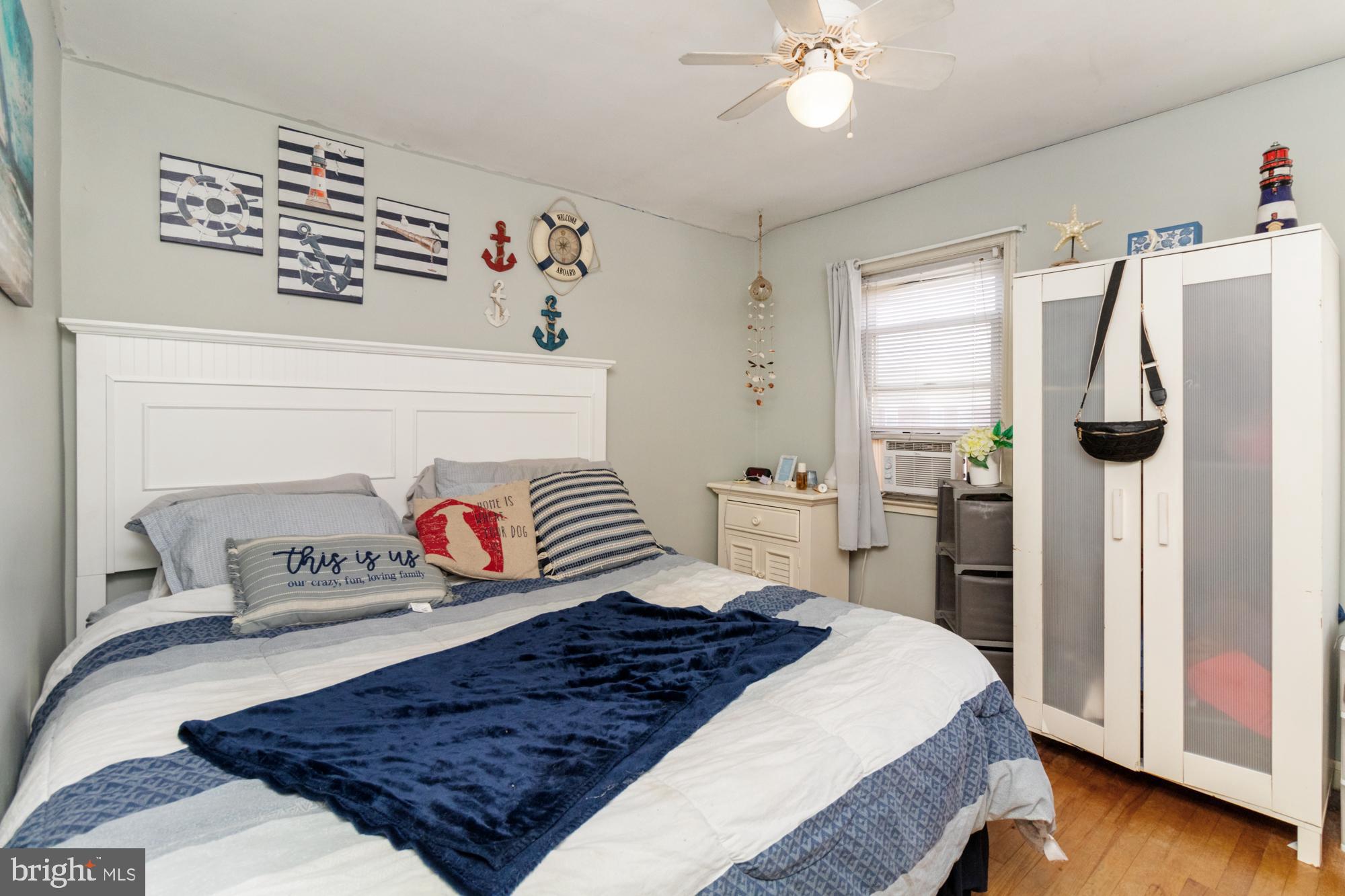 3435 Dunran Road Baltimore, MD 21222 - Photo 26 of 46 a bedroom with a large bed and a chandelier