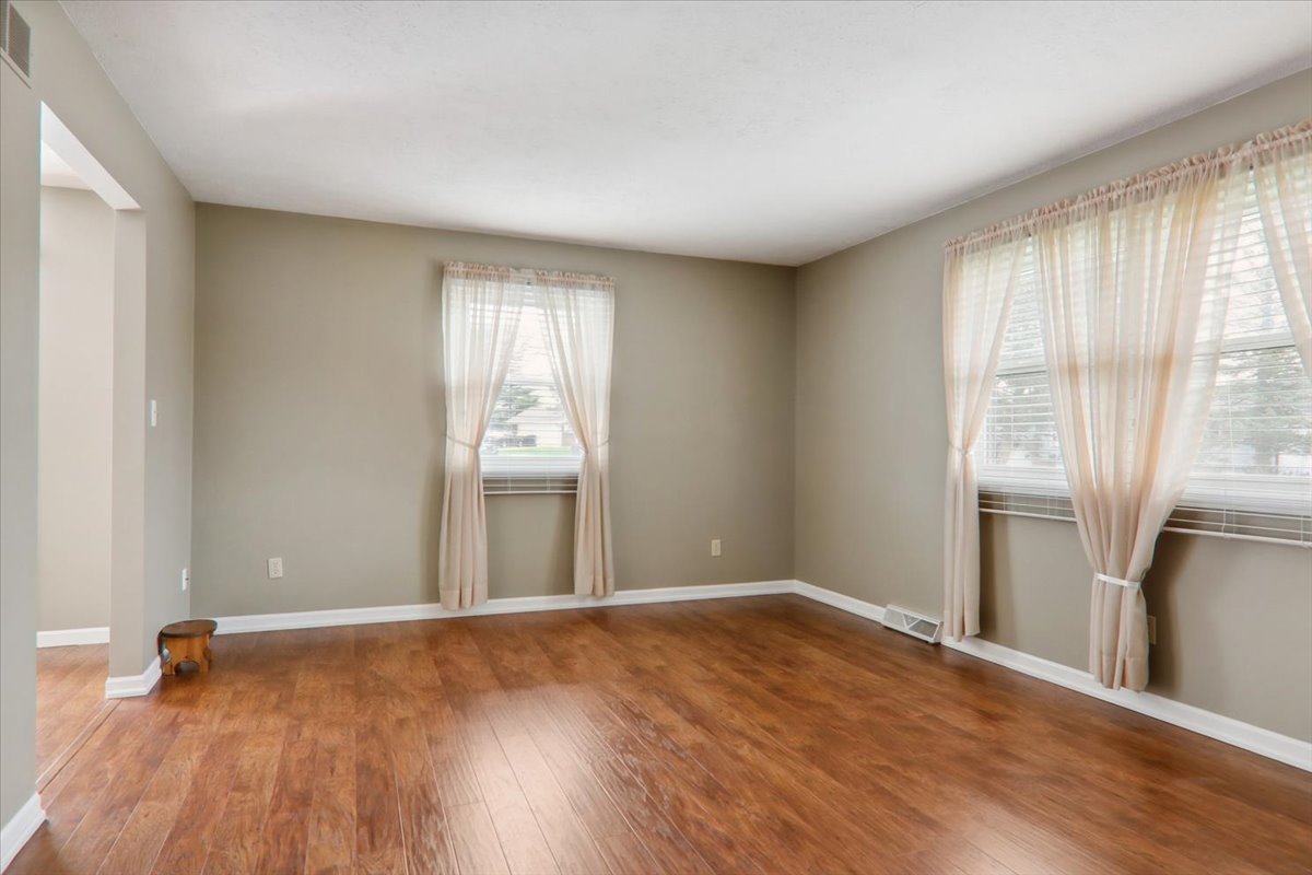 720 Lara Road Normal, IL 61761 - Photo 14 of 30 an empty room with wooden floor and windows