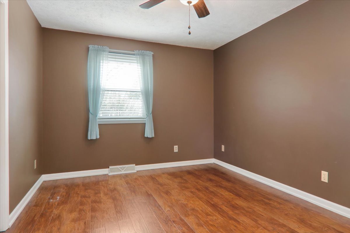 720 Lara Road Normal, IL 61761 - Photo 16 of 30 an empty room with a window and wooden floor