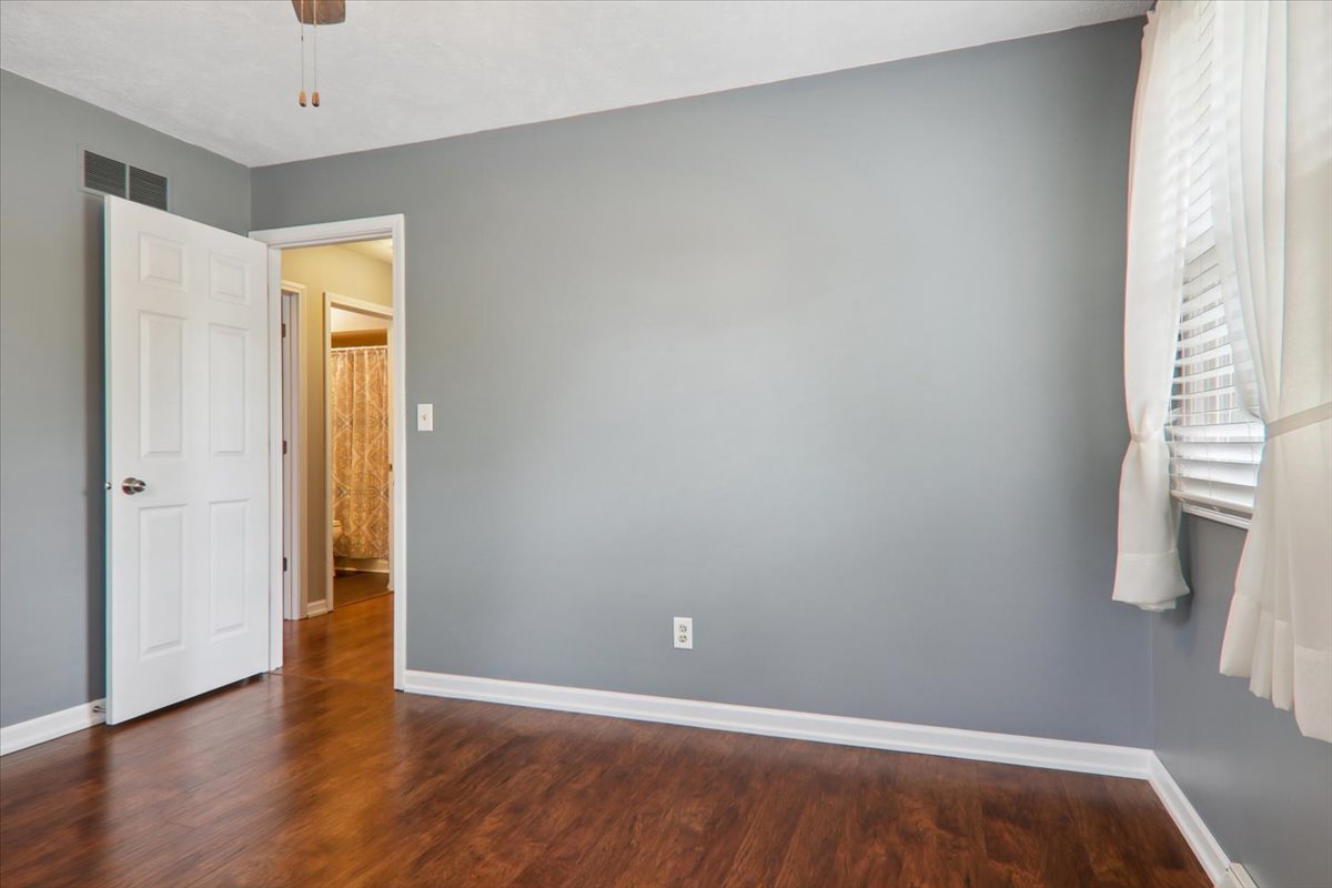 720 Lara Road Normal, IL 61761 - Photo 19 of 30 a view of an empty room with wooden floor and a window