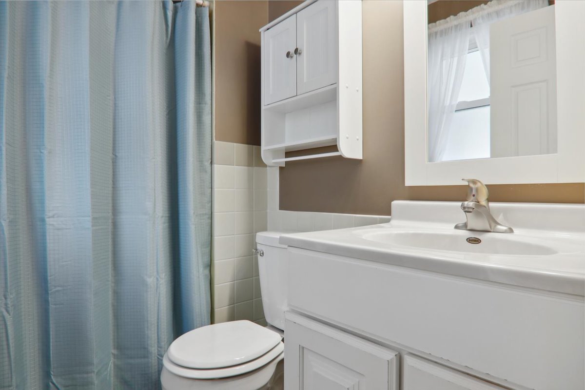 720 Lara Road Normal, IL 61761 - Photo 21 of 30 a bathroom with a sink toilet and mirror