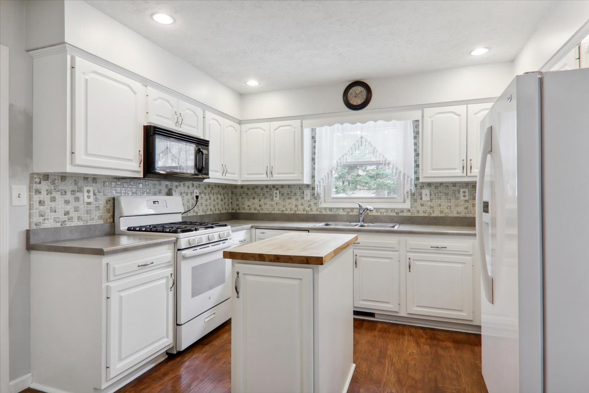 720 Lara Road Normal, IL 61761 - Photo 9 of 30 a kitchen with stainless steel appliances granite countertop a stove a sink and white cabinets