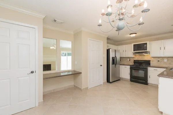 a view of a kitchen with a sink and stainless steel appliances