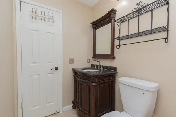a bathroom with a sink a toilet and mirror