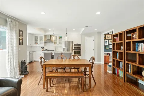a view of a dining room with furniture and a book shelf
