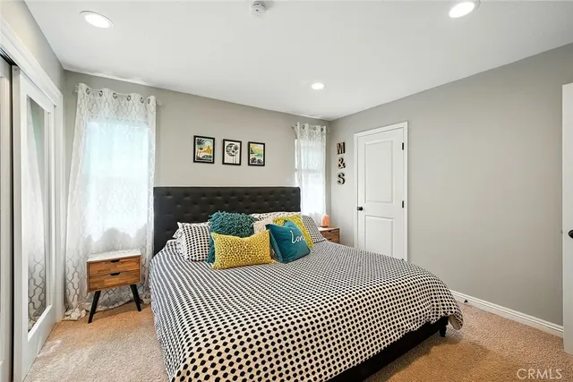 a bedroom with a bed and a night stand