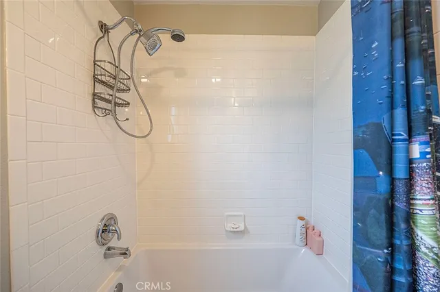 a bathroom with a shower and a bathtub