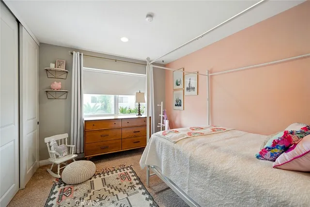 a bedroom with a bed and view of living room