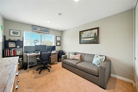 a living room with furniture and a work place area
