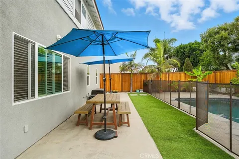 a backyard of a house with table and chairs